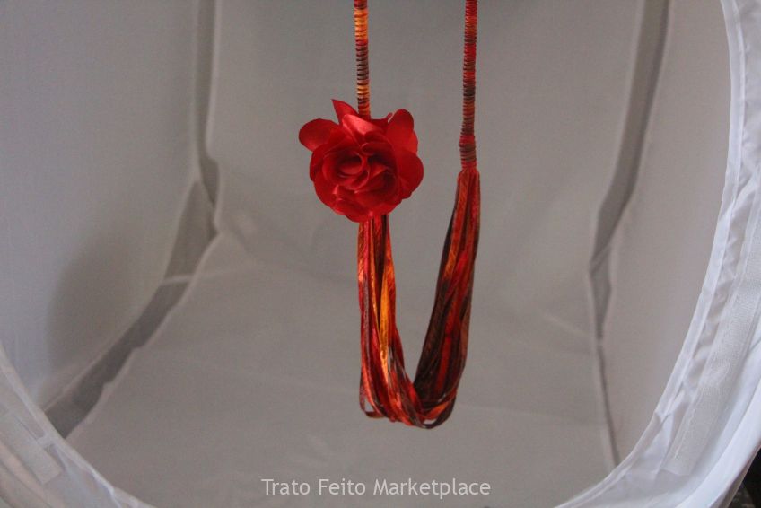 Colar de fita de seda manchada de vermelho.
